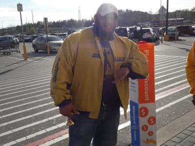 A Man Standing In A Parking Lot
